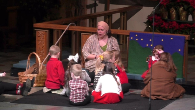 A picture of kids sitting around the leader at Central UMC's family christmas