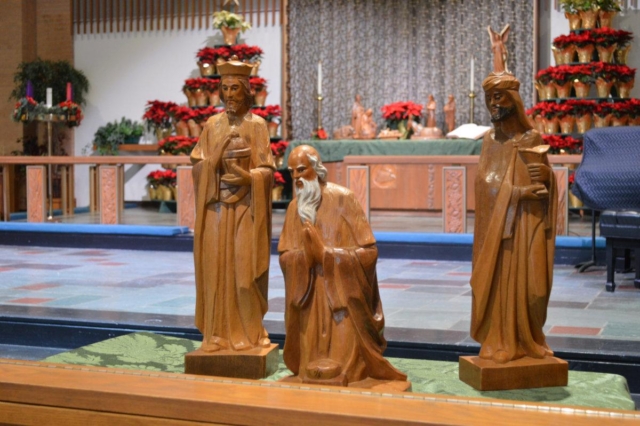 A close-up of the 3 kings from Central's wooden nativity scene with the remainder of the scene in the background