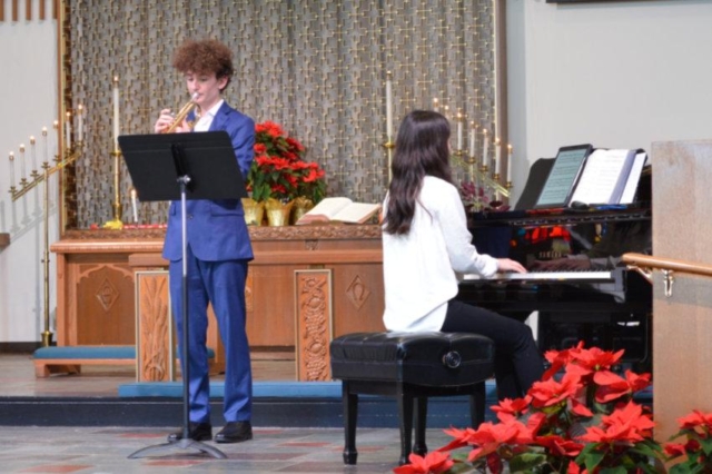 A young man playing trumpet and a young woman playing piano at Central United Methodist Church in Waterford MI