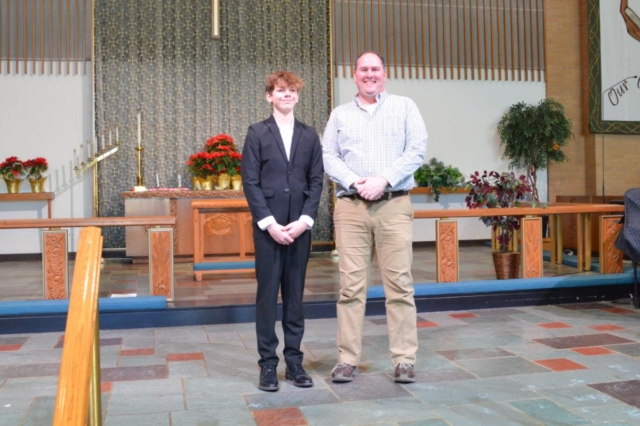 A young man standing to the left of his confirmation mentor at Central United Methodist Church in Waterford MI