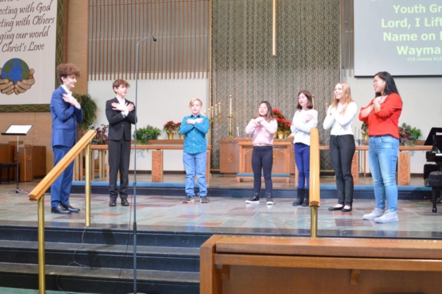 Six youth standing on the chancel as they sing at Waterford Central United Methodist Church in Waterford, MI