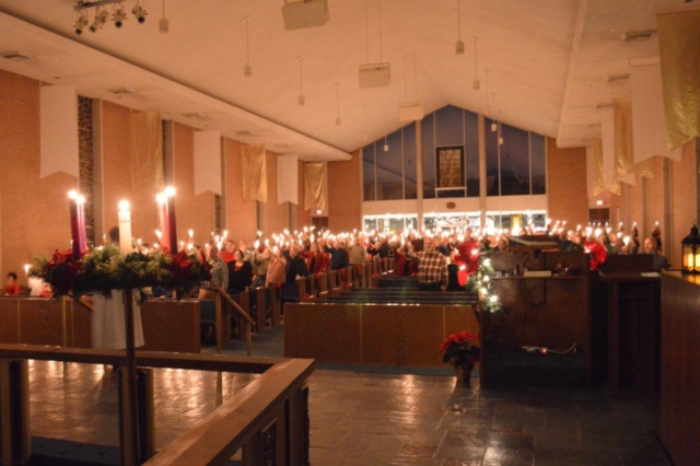 Long shot of the Sanctuary with congregation with raised candles at Waterford Central United Methodist Church in Waterford, MI