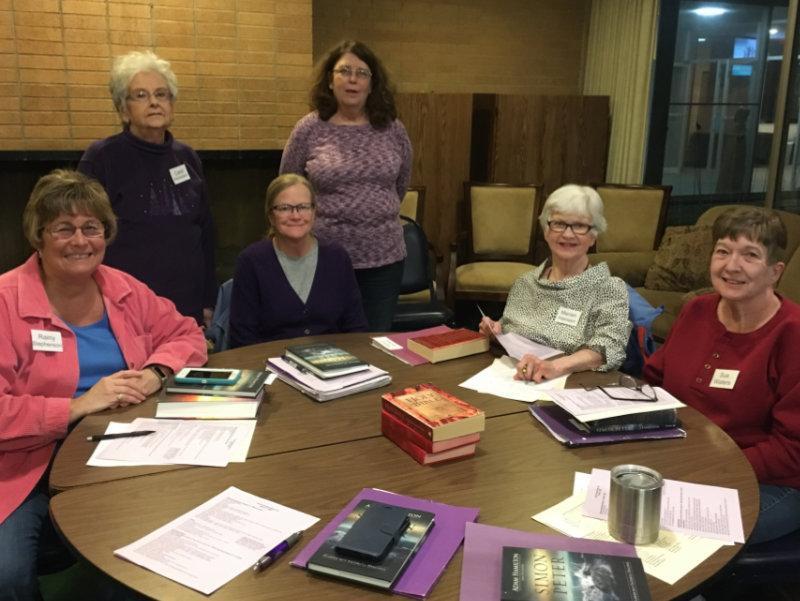 A group of women sitting around a table with books and papers at Waterford Central UMC in MI.