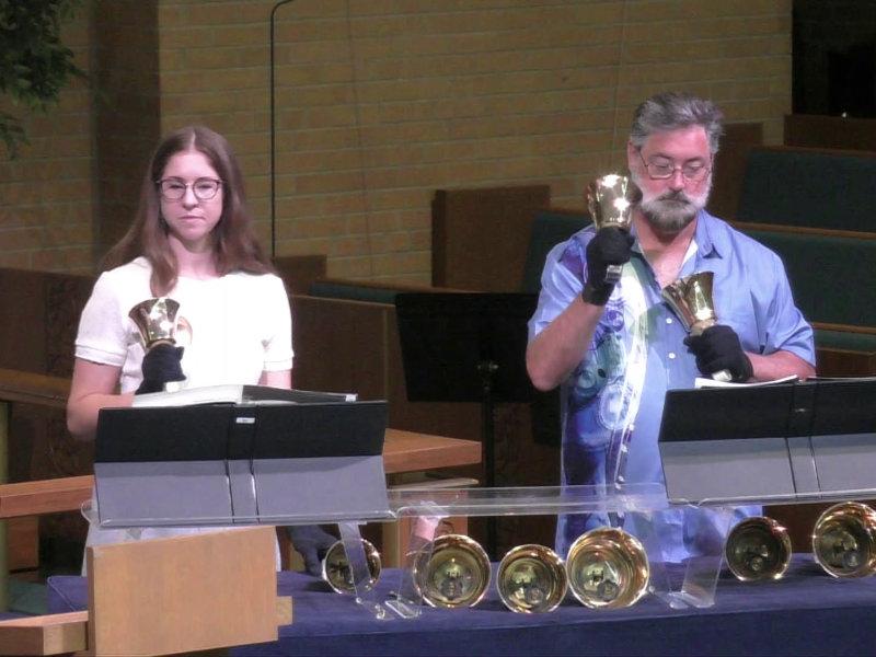 Two people from Central United Methodist Church in Waterford, MI ringing handbells during worship