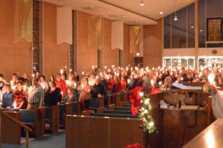 A wide shot of Christmas Eve Silent Night with lit candles at Waterford CUMC in Michigan