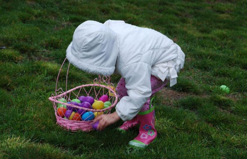 Picture of a little girl hunting for Easter eggs